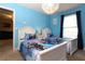 Bright bedroom featuring two beds with 'Frozen' themed bedding and light blue walls at 5384 Oakbourne Ave, Davenport, FL 33837