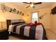 Comfortable bedroom with a music theme with fan and mounted guitar at 5384 Oakbourne Ave, Davenport, FL 33837