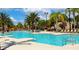 A spacious pool with lounge chairs and palm trees for a resort-like experience at 5384 Oakbourne Ave, Davenport, FL 33837