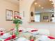 A modern dining room features a glass table with white chairs at 5384 Oakbourne Ave, Davenport, FL 33837