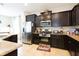 Well-equipped kitchen featuring stainless steel appliances, dark wood cabinetry, and granite countertops at 5384 Oakbourne Ave, Davenport, FL 33837