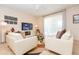 Inviting living room showcasing tile flooring, comfortable seating, a ceiling fan, and a large TV at 5384 Oakbourne Ave, Davenport, FL 33837