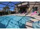 A screened-in pool area with a pool and a hot tub at 5384 Oakbourne Ave, Davenport, FL 33837