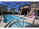 A screened-in pool area with a pool and lounge chairs at 5384 Oakbourne Ave, Davenport, FL 33837