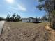 A home's expansive backyard with a road and trees in the background at 616 Marion Oaks Ln, Ocala, FL 34473