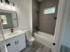 This bathroom is sleek and modern, with gray tile, and matte black hardware at 616 Marion Oaks Ln, Ocala, FL 34473