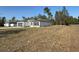 Single Gathering home with a gray garage door, stone accents, and a large front yard at 616 Marion Oaks Ln, Ocala, FL 34473