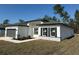 Single Gathering home featuring stone accents, a gray roof, and manicured landscaping at 616 Marion Oaks Ln, Ocala, FL 34473