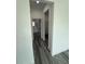 Hallway featuring wood-look floors leading towards the bathroom with white cabinets and modern fixtures at 616 Marion Oaks Ln, Ocala, FL 34473