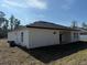 A home's rear exterior featuring a covered lanai, well kept yard, and a dark roof at 616 Marion Oaks Ln, Ocala, FL 34473