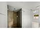 Contemporary bathroom featuring a glass shower with dark brown wood-look tile and chrome fixtures at 662 Sausalito Blvd, Casselberry, FL 32707