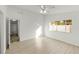 Clean bedroom with a ceiling fan, large window for natural light, and wood-look laminate flooring at 662 Sausalito Blvd, Casselberry, FL 32707