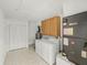 Functional laundry room with washer, dryer, cabinets, water heater, and ample storage space at 662 Sausalito Blvd, Casselberry, FL 32707