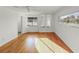 Bright living room with hardwood floors, built-in shelves, a ceiling fan, and natural light from the windows at 662 Sausalito Blvd, Casselberry, FL 32707