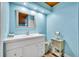 Bathroom featuring a wood paneled ceiling, a large mirror, and a vanity at 721 Glenridge Way, Winter Park, FL 32789