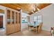 Charming dining room adjacent to the kitchen, featuring a wood ceiling, and a built-in display cabinet at 721 Glenridge Way, Winter Park, FL 32789