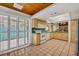 Functional kitchen with wood cabinets, green backsplash, and sliding doors leading to an outdoor area at 721 Glenridge Way, Winter Park, FL 32789