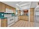 Cozy kitchen features tiled countertops and floors, white appliances, and bright lighting at 721 Glenridge Way, Winter Park, FL 32789