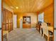 Home office with wood paneled walls, built-in shelves, a desk and plenty of natural light from the window at 721 Glenridge Way, Winter Park, FL 32789