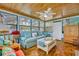 Charming sunroom featuring comfortable seating, a wood paneled ceiling, and abundant natural light at 721 Glenridge Way, Winter Park, FL 32789