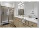 Bathroom featuring double sinks, a glass-enclosed shower, and neutral decor at 8005 Flip Flop Way, Kissimmee, FL 34747