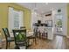 Bright dining area featuring a round table, stylish chairs, pendant lighting, and a view of the kitchen at 8005 Flip Flop Way, Kissimmee, FL 34747