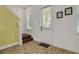 Bright entryway featuring wood-look tile flooring, staircase, and a white front door with glass window at 8005 Flip Flop Way, Kissimmee, FL 34747