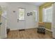 Bright entryway showcasing a white front door, wood-look tile flooring, and a comfortable chair at 8005 Flip Flop Way, Kissimmee, FL 34747