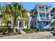 A colorful cottage-style home with tropical landscaping and a welcoming front porch entrance at 8005 Flip Flop Way, Kissimmee, FL 34747