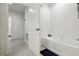 Bright bathroom features a tiled shower-over-tub and linen closet for storage at 841 Benjamin Trl, Davenport, FL 33837