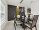 Modern dining room features contemporary lighting and a custom accent wall with an adjacent serving area at 841 Benjamin Trl, Davenport, FL 33837