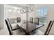 Elegant dining room featuring a modern light fixture, statement wall, and a sleek dining table at 841 Benjamin Trl, Davenport, FL 33837