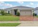 Charming single-story home featuring a brick driveway, neutral paint, and a well-maintained lawn at 841 Benjamin Trl, Davenport, FL 33837