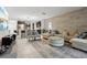 Inviting living room featuring wood-look accent wall, tile floors, and access to the kitchen at 841 Benjamin Trl, Davenport, FL 33837