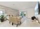 Open-concept living room with tiled floors, a decorative accent wall, and sliding doors leading to the backyard at 841 Benjamin Trl, Davenport, FL 33837