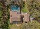 Overhead aerial view of home, swimming pool, and detached garage at 9332 Windy Ridge Rd, Windermere, FL 34786