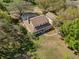 Aerial view of a charming two-story home with a large pool, expansive yard, and mature trees at 9332 Windy Ridge Rd, Windermere, FL 34786