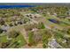 Scenic aerial view of estate surrounded by beautiful lakes and lush landscape at 9332 Windy Ridge Rd, Windermere, FL 34786