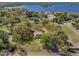 Aerial view of home surrounded by lush yard and lakes at 9332 Windy Ridge Rd, Windermere, FL 34786