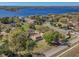 Aerial view of a lakefront community, highlighting a home with a sprawling lot and picturesque surroundings at 9332 Windy Ridge Rd, Windermere, FL 34786