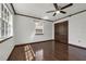 Bedroom featuring a ceiling fan, hardwood floors, and bright windows with a view to the outdoors at 9332 Windy Ridge Rd, Windermere, FL 34786