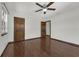 The bedroom is complete with hardwood floors, base trim, and neutral paint at 9332 Windy Ridge Rd, Windermere, FL 34786