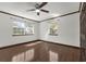 Bedroom featuring light from two windows, a ceiling fan, and beautiful dark-stained trim and baseboards at 9332 Windy Ridge Rd, Windermere, FL 34786