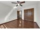 This bedroom features a ceiling fan, hardwood floors, and closet space for plenty of storage at 9332 Windy Ridge Rd, Windermere, FL 34786