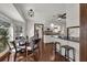 Cozy breakfast nook with a glass table, wood floors, and views of the adjoining kitchen area at 9332 Windy Ridge Rd, Windermere, FL 34786