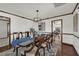 Dining room with hardwood floors, a large table with seating for six, and a view to another room at 9332 Windy Ridge Rd, Windermere, FL 34786