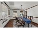 Spacious dining room featuring a long wooden table with seating for six, complemented by a modern chandelier and hardwood floors at 9332 Windy Ridge Rd, Windermere, FL 34786