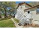 Exterior view of the home shows a yard and a stairway to a private entrance at 9332 Windy Ridge Rd, Windermere, FL 34786