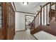 Light-filled foyer featuring decorative glass doors, a staircase, and tiled flooring at 9332 Windy Ridge Rd, Windermere, FL 34786