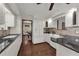 Well-lit kitchen with white cabinetry, granite countertops, and stainless steel appliances, offering a functional and stylish cooking space at 9332 Windy Ridge Rd, Windermere, FL 34786